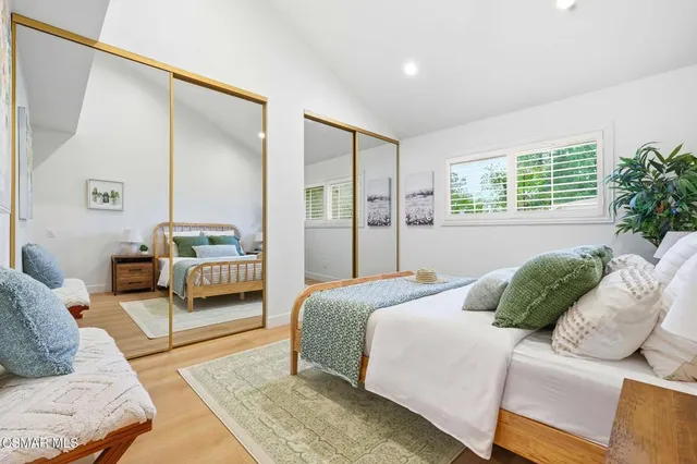 a bedroom with a bed couch and a window