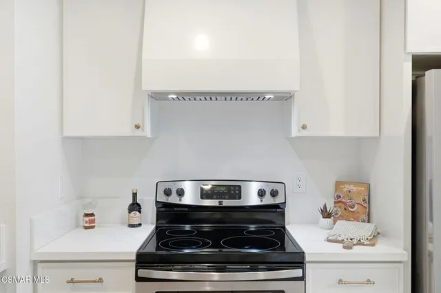 a stove top oven sitting inside of a kitchen