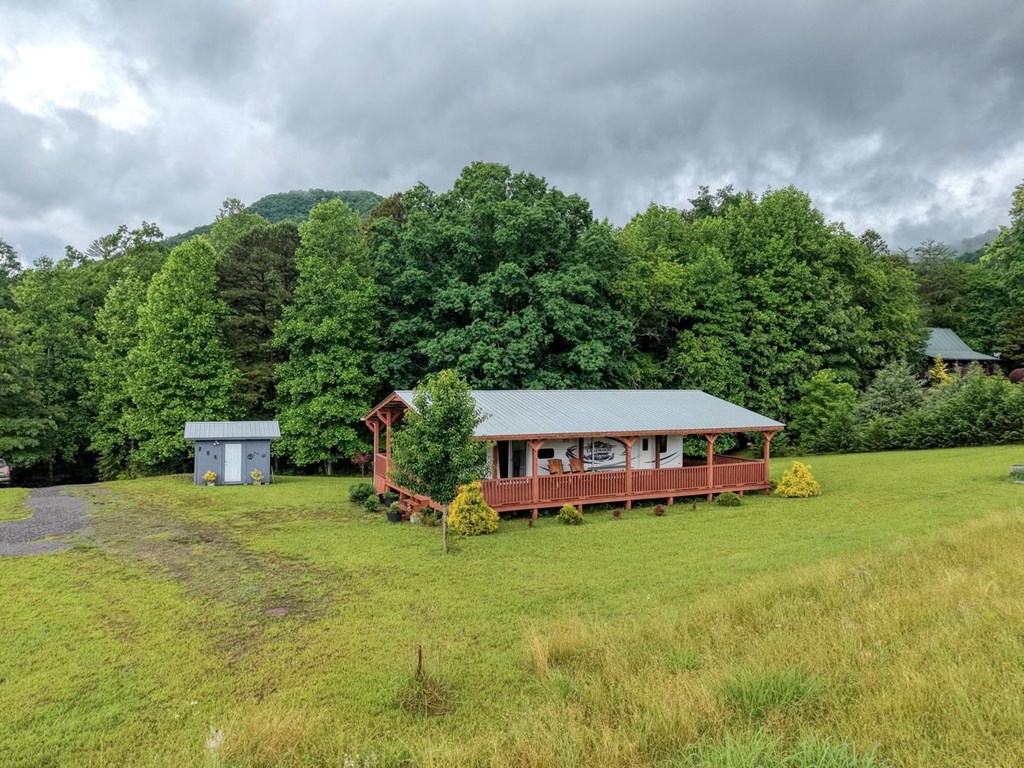 568 Parks Road Hiawassee, GA 30546 - Photo 2 of 38 a view of a house with a big yard and large trees