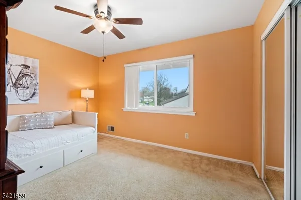 a living room with furniture and a ceiling fan