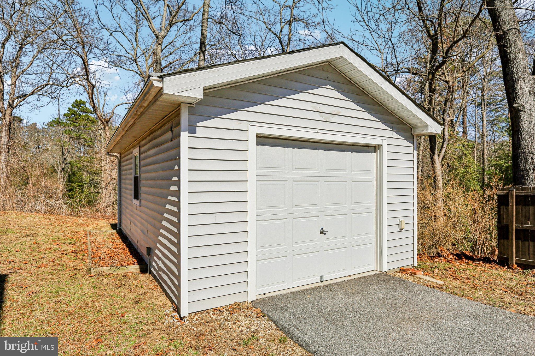 306 Christy Road Pasadena, MD 21122 - Photo 55 of 58 Charming garage nestled in nature's embrace.