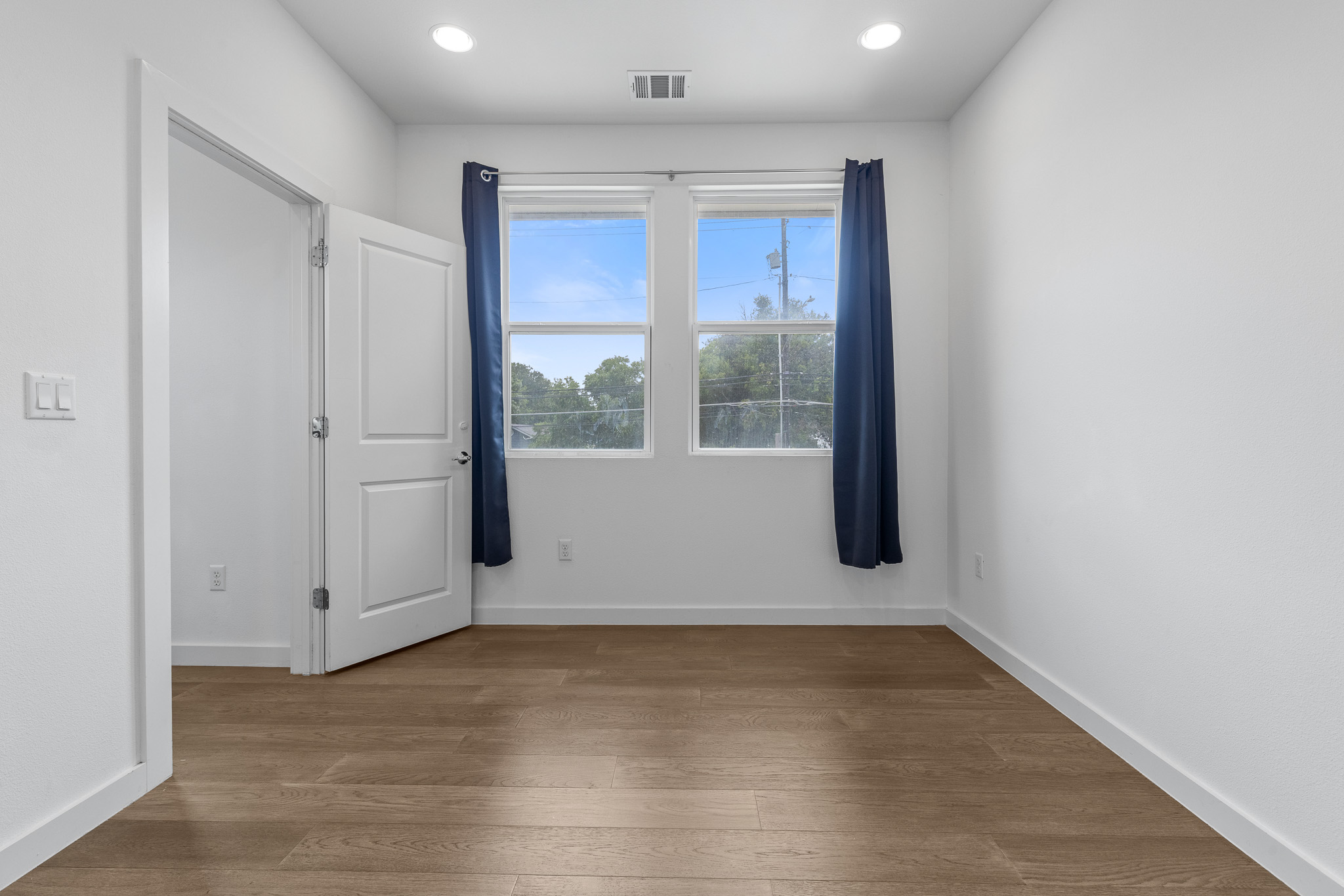 2604 Wheless Lane, Unit 1 Austin, TX 78723 - Photo 18 of 38 Warm hardwood flooring creates inviting, comfortable bedroom atmosphere.
