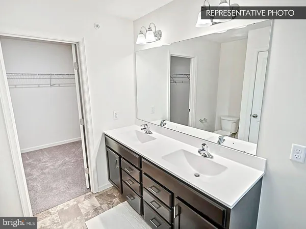 a bathroom with a sink a mirror and a vanity