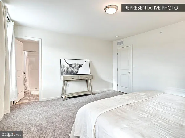 a bedroom with a bed and dresser