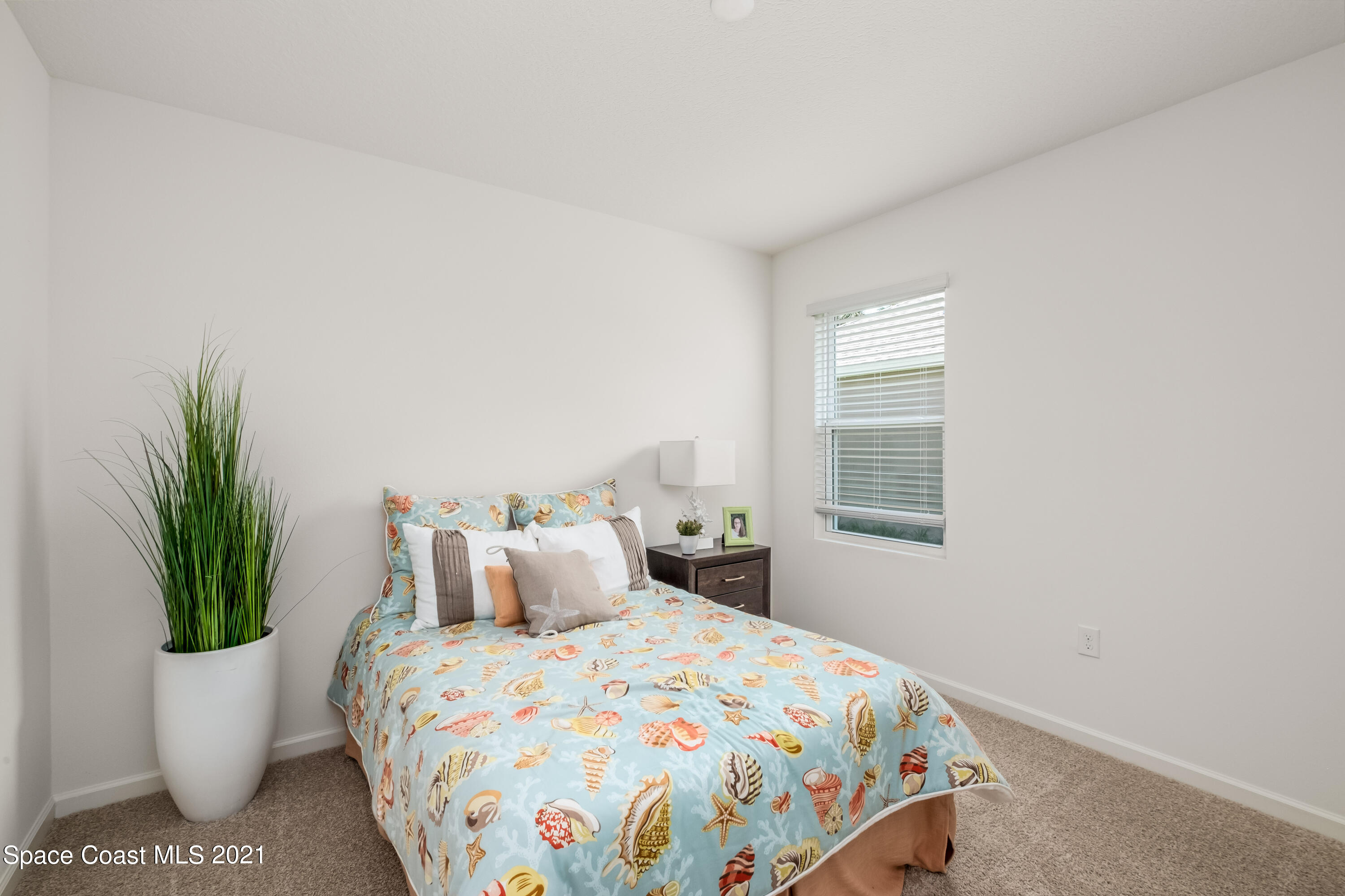 4631 Talbot Boulevard Cocoa, FL 32926 - Photo 15 of 23 a bedroom with a bed and a potted plant