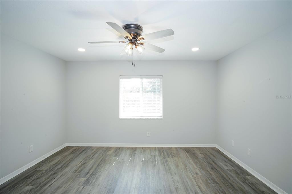 10523 Southwest 62nd Ter Road Ocala, FL 34476 - Photo 11 of 38 wooden floor in an empty room with a window
