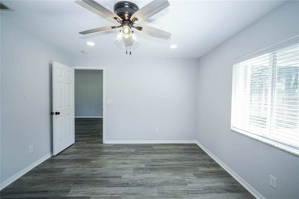10523 Southwest 62nd Ter Road Ocala, FL 34476 - Photo 12 of 38 wooden floor in an empty room with a window