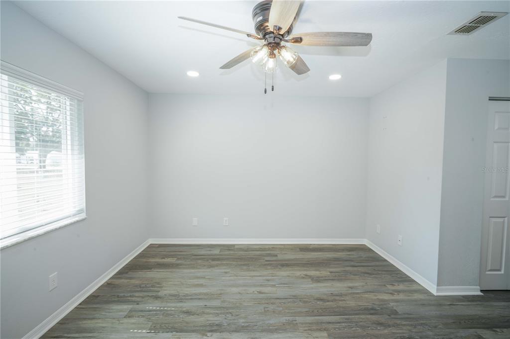 10523 Southwest 62nd Ter Road Ocala, FL 34476 - Photo 13 of 38 a view of an empty room with wooden floor and a window