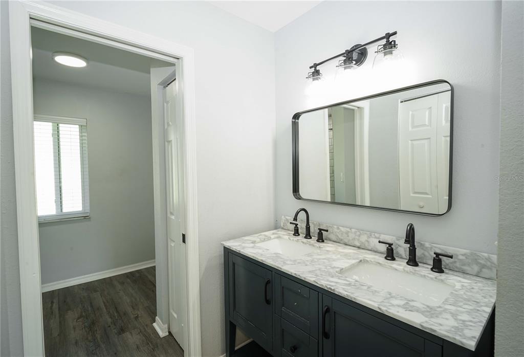 10523 Southwest 62nd Ter Road Ocala, FL 34476 - Photo 14 of 38 a bathroom with a granite countertop sink and a mirror