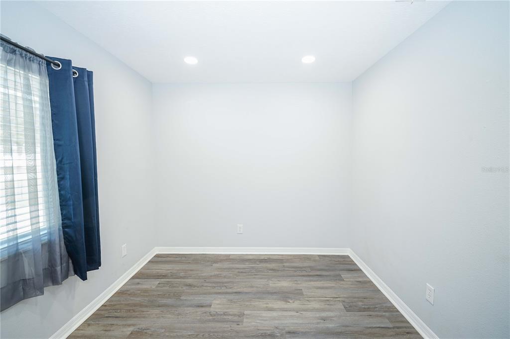10523 Southwest 62nd Ter Road Ocala, FL 34476 - Photo 17 of 38 a view of an empty room with wooden floor and a window