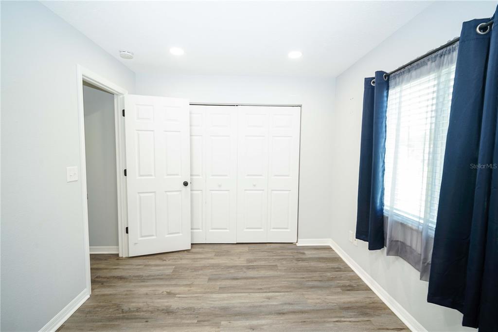 10523 Southwest 62nd Ter Road Ocala, FL 34476 - Photo 18 of 38 wooden floor in an empty room with a window