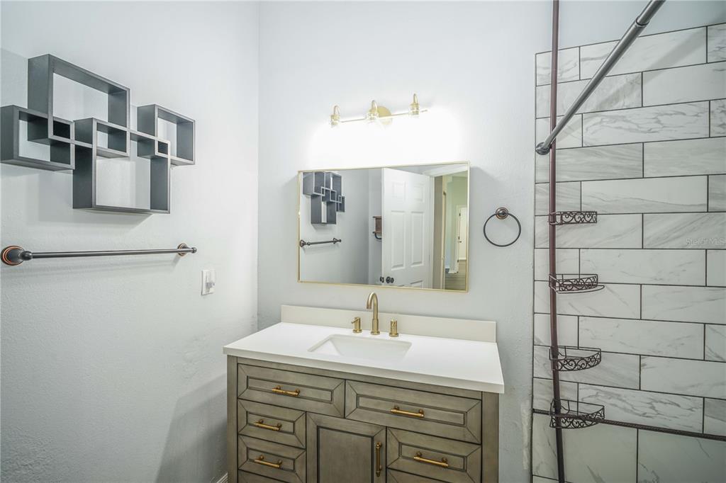 10523 Southwest 62nd Ter Road Ocala, FL 34476 - Photo 19 of 38 a bathroom with a sink and a mirror