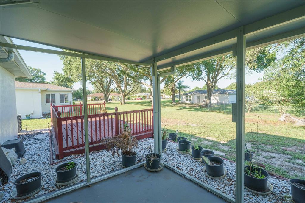 10523 Southwest 62nd Ter Road Ocala, FL 34476 - Photo 27 of 38 a view of a porch with furniture and floor to ceiling window