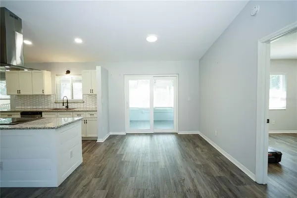 a large kitchen with a hard wood floor