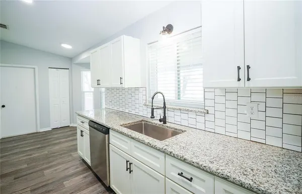 a kitchen with a sink and cabinets