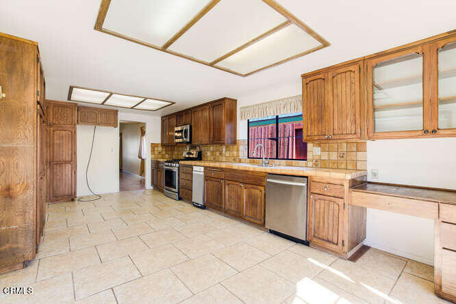 3020 Jacktar Avenue Oxnard, CA 93035 - Photo 11 of 31 a kitchen with stainless steel appliances granite countertop a stove a sink and a refrigerator