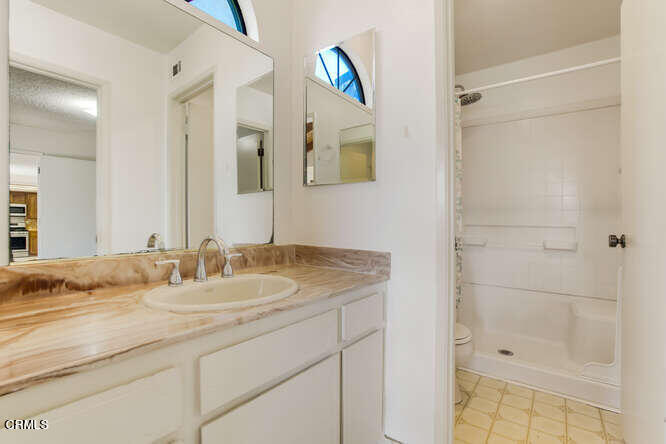 3020 Jacktar Avenue Oxnard, CA 93035 - Photo 14 of 31 a bathroom with a granite countertop sink and a mirror