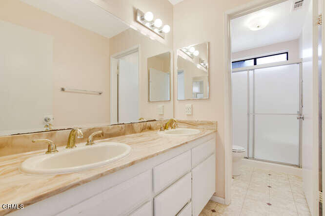 3020 Jacktar Avenue Oxnard, CA 93035 - Photo 21 of 31 a bathroom with a granite countertop sink and a mirror