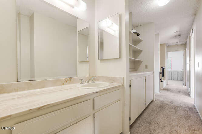 3020 Jacktar Avenue Oxnard, CA 93035 - Photo 22 of 31 a spacious bathroom with a shower sink and mirror