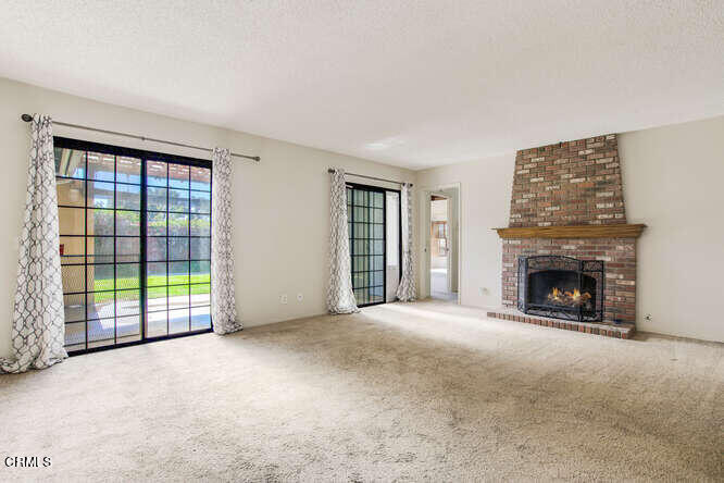 3020 Jacktar Avenue Oxnard, CA 93035 - Photo 5 of 31 a view of an empty room with a fireplace and a window