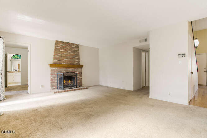 3020 Jacktar Avenue Oxnard, CA 93035 - Photo 6 of 31 an empty room with a fireplace and painted walls