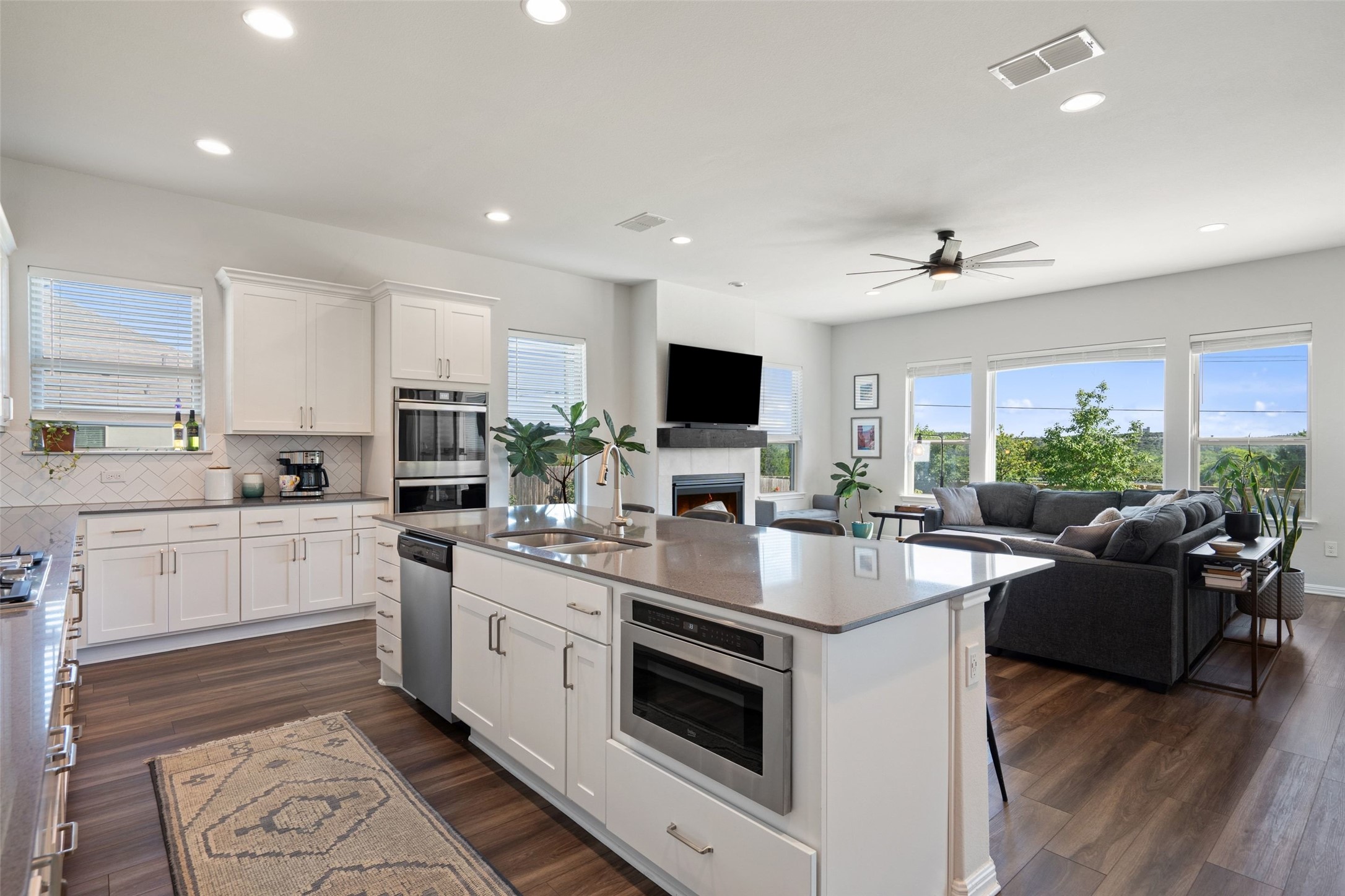 162 Lunar Loop Austin, TX 78737 - Photo 10 of 40 a kitchen with a sink stove and microwave