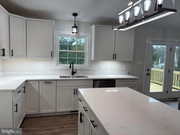 a kitchen with a sink cabinets and window