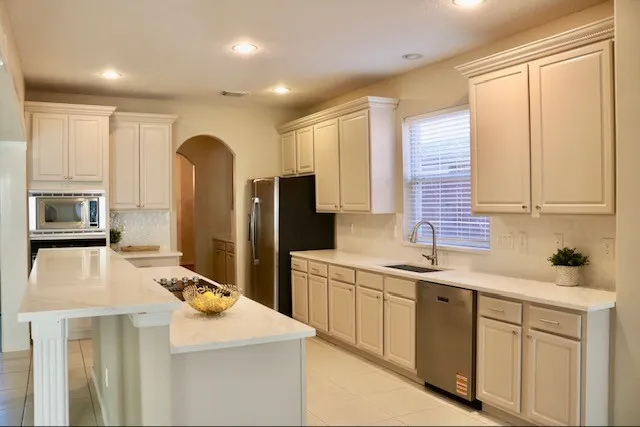 a kitchen with a sink stove and refrigerator