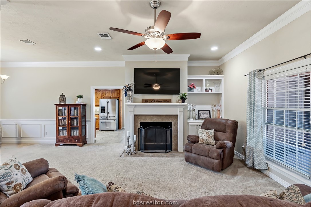 2700 Hickory Court Bryan, TX 77808 - Photo 6 of 31 Living room with built in shelving, gas fireplace & mantle