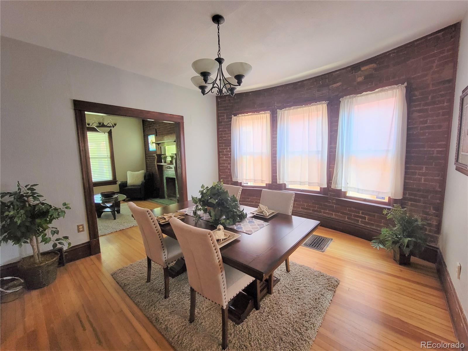 2835 Decatur Street Denver, CO 80211 - Photo 11 of 32 a view of a dining room with furniture window and wooden floor