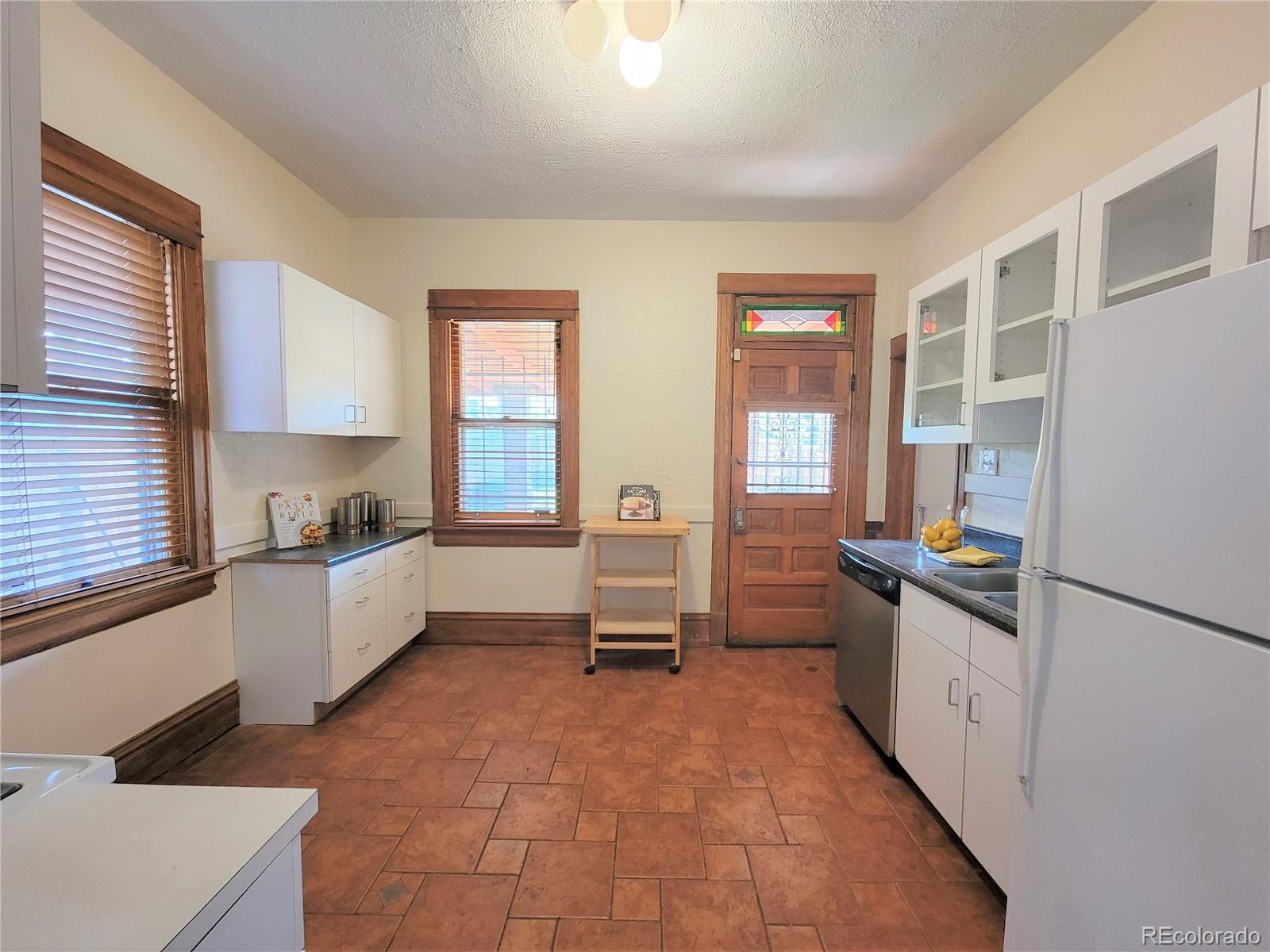 2835 Decatur Street Denver, CO 80211 - Photo 14 of 32 a large kitchen with a large window and stainless steel appliances