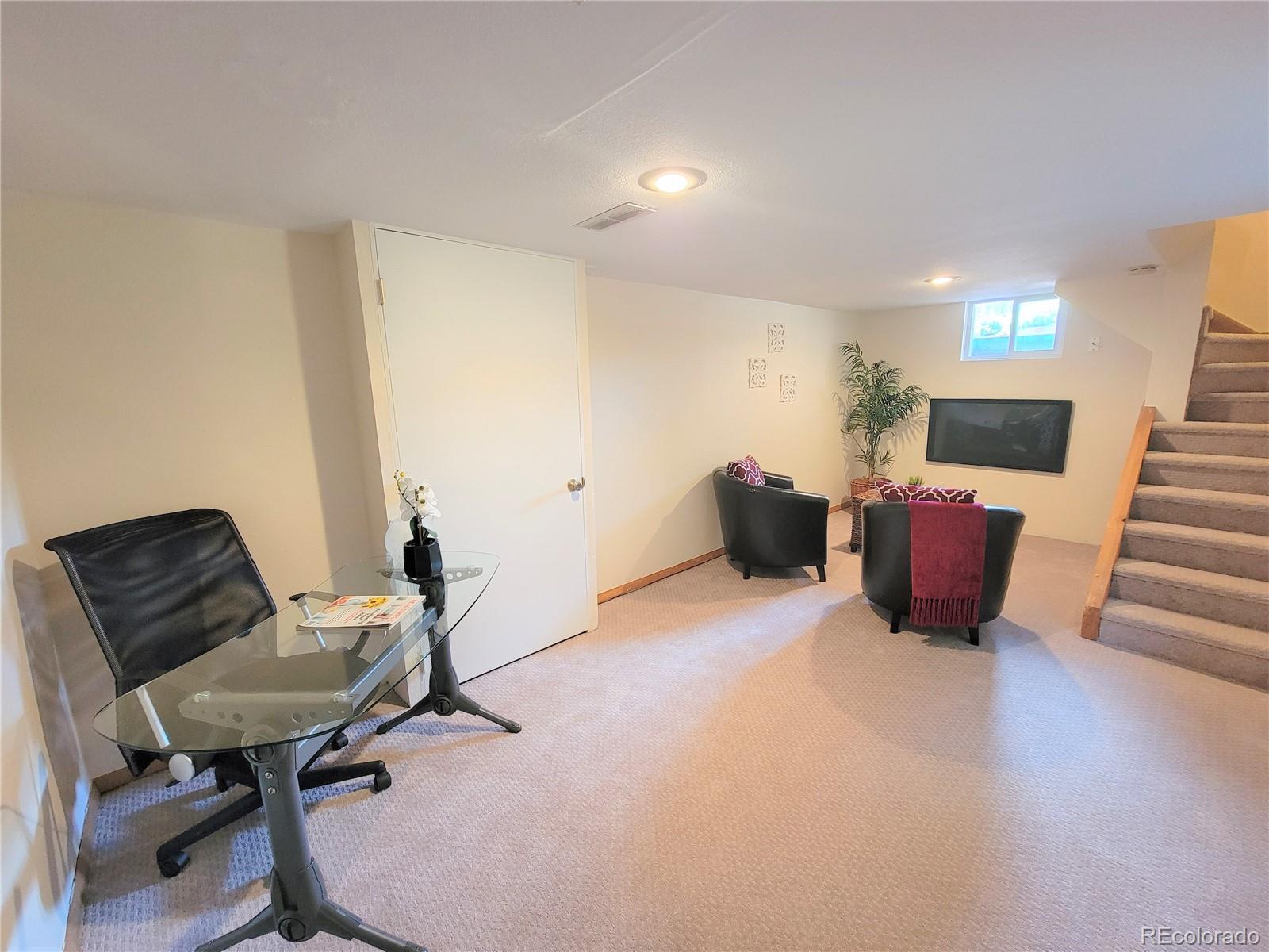 2835 Decatur Street Denver, CO 80211 - Photo 24 of 32 a living room with furniture and a chair