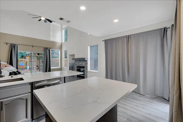 a kitchen with stainless steel appliances granite countertop a sink stove microwave and refrigerator