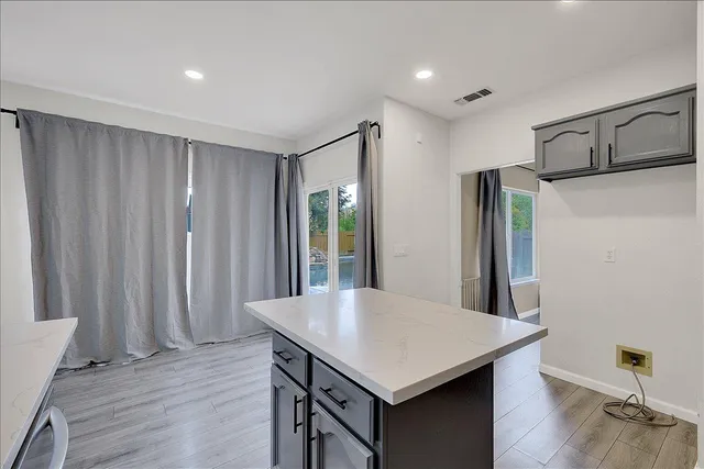 a view of empty room with wooden floor and fireplace