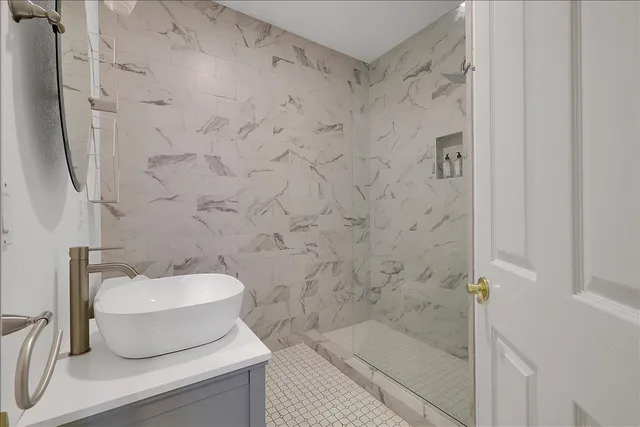 a bathroom with a toilet sink and mirror