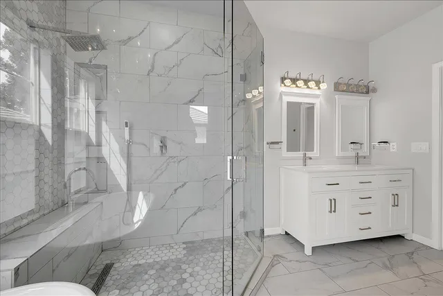 a kitchen with white cabinets and sink