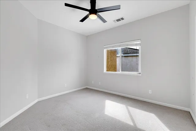 an empty room with a empty space and windows