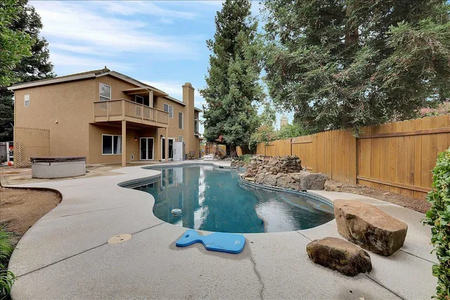 a view of a swimming pool with a patio