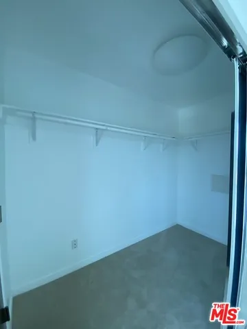 a view of a patio with couches potted plants and a table