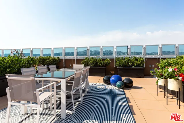 a view of a chairs and table in a patio