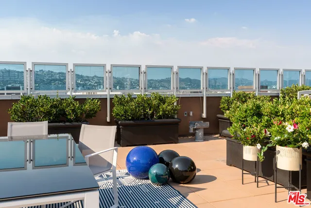 a roof deck with a table and chairs