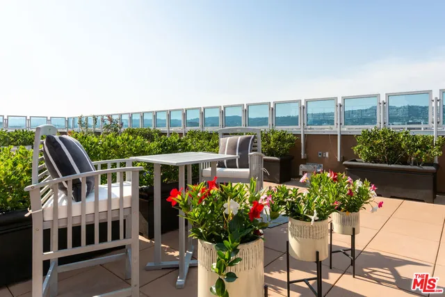 a view of a patio with table and chairs potted plants with wooden floor