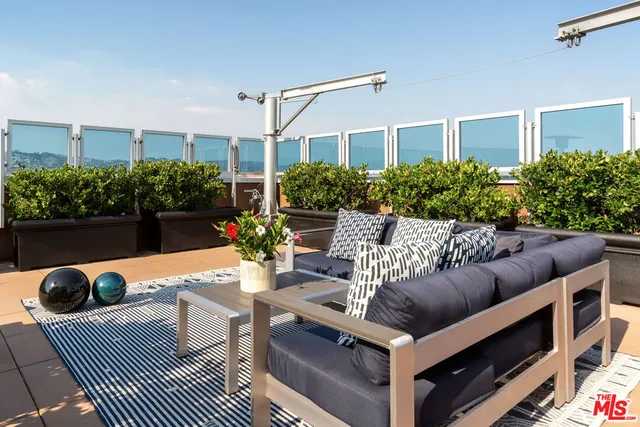 a view of a patio with a table and chairs