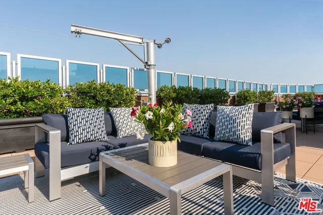 a view of a patio with couches and potted plants
