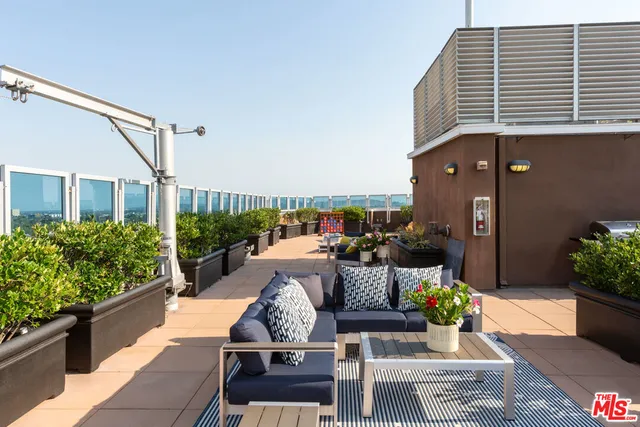 a outdoor living space with furniture and a potted plant