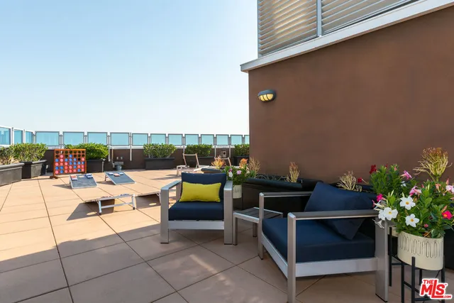a view of swimming pool with outdoor seating and plants