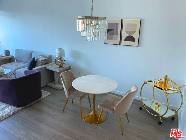 a view of a workspace with furniture and wooden floor