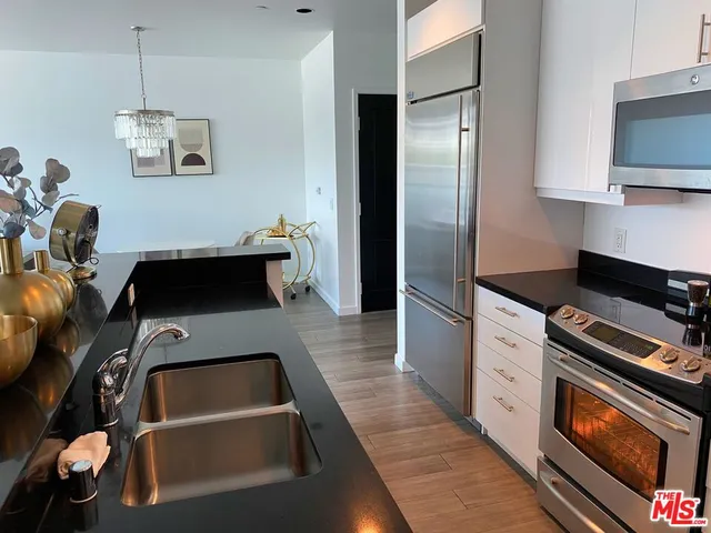 a kitchen with a refrigerator and a stove top oven