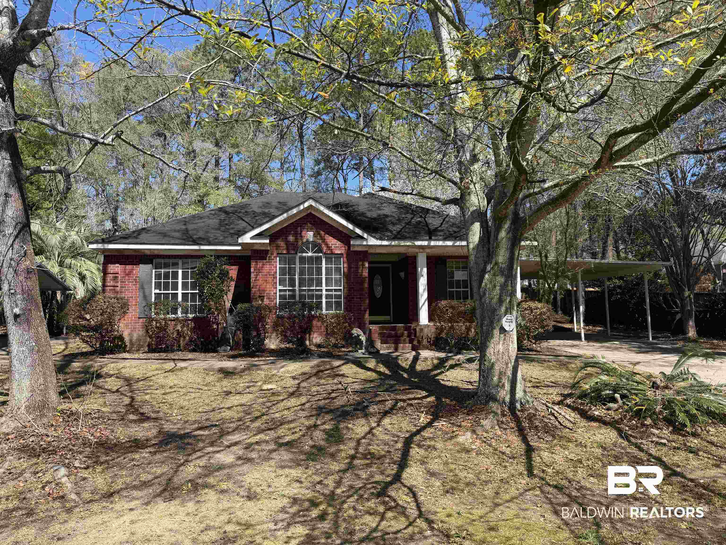 7067 Pinehill Road Daphne, AL 36526 - Photo 2 of 18 Ranch-style home featuring a carport, brick siding, and covered porch