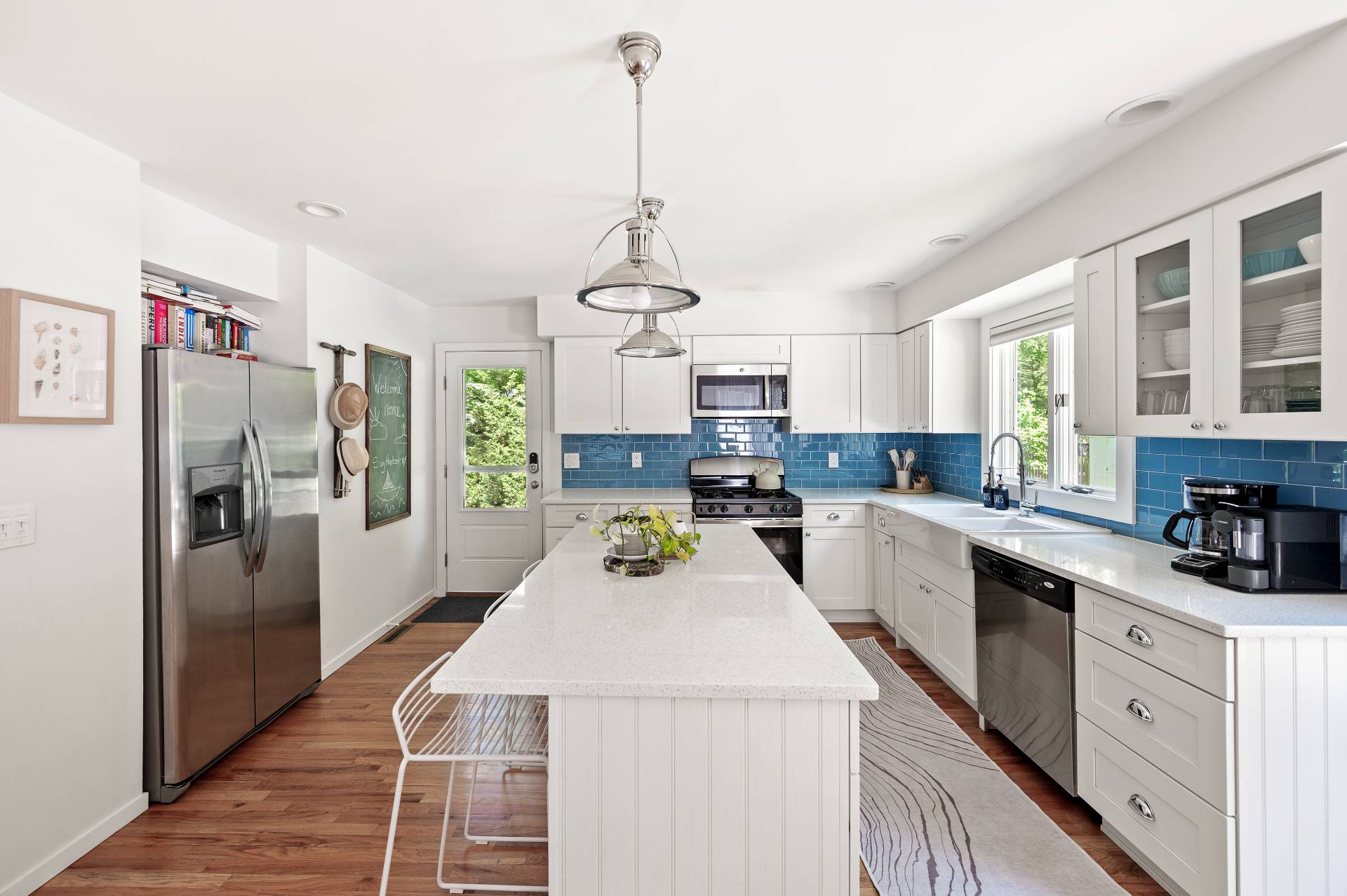 4594 Noyack Road Sag Harbor, NY 11963 - Photo 11 of 31 a kitchen with sink a refrigerator and cabinets